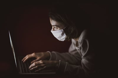 image woman working and wearing mask in times of pandemic