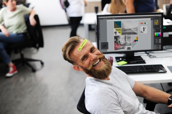 man is happy at work: positive reinforcement